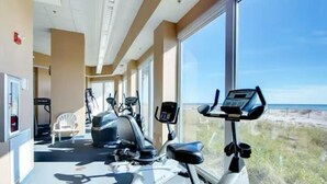 A gym with cardio machines and a view of the beach. - Lighthouse Condo 717-King Bed, Queen Sleeper, Twin Bunk Beds, 2 bath, sleeps 6 (Gulf Shores)