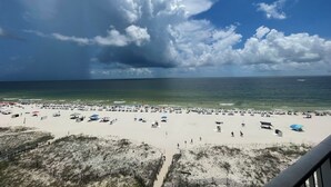 A beach with a sandy shore, a wooden fence, and a view of the ocean. - Lighthouse Condo 717-King Bed, Queen Sleeper, Twin Bunk Beds, 2 bath, sleeps 6 (Gulf Shores)