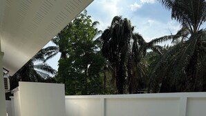 A rectangular swimming pool with clear water, surrounded by a white wall and a tiled deck. - Passara Villas (Krabi)