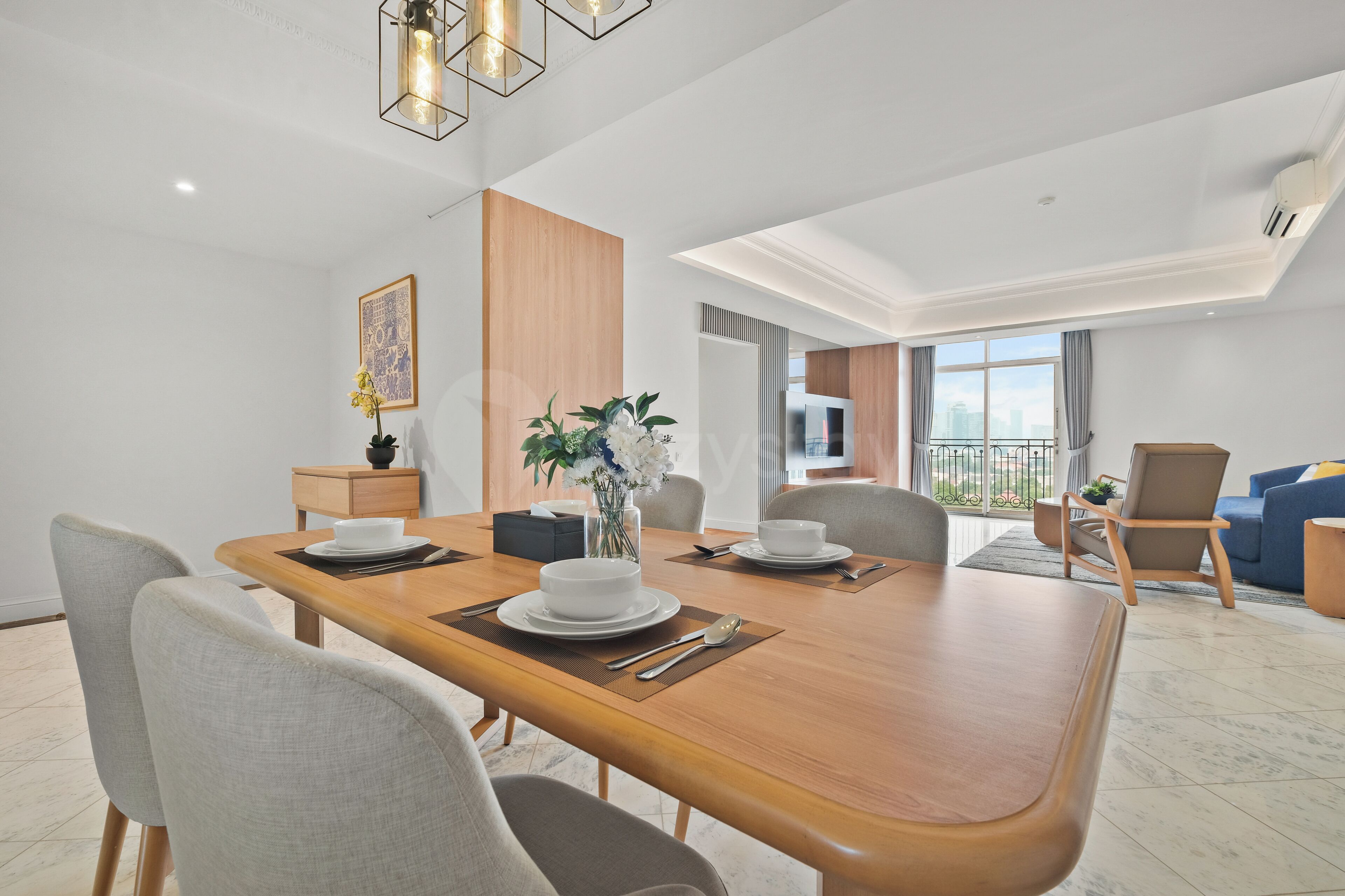 A modern dining area with a wooden table, chairs, and a vase of flowers.