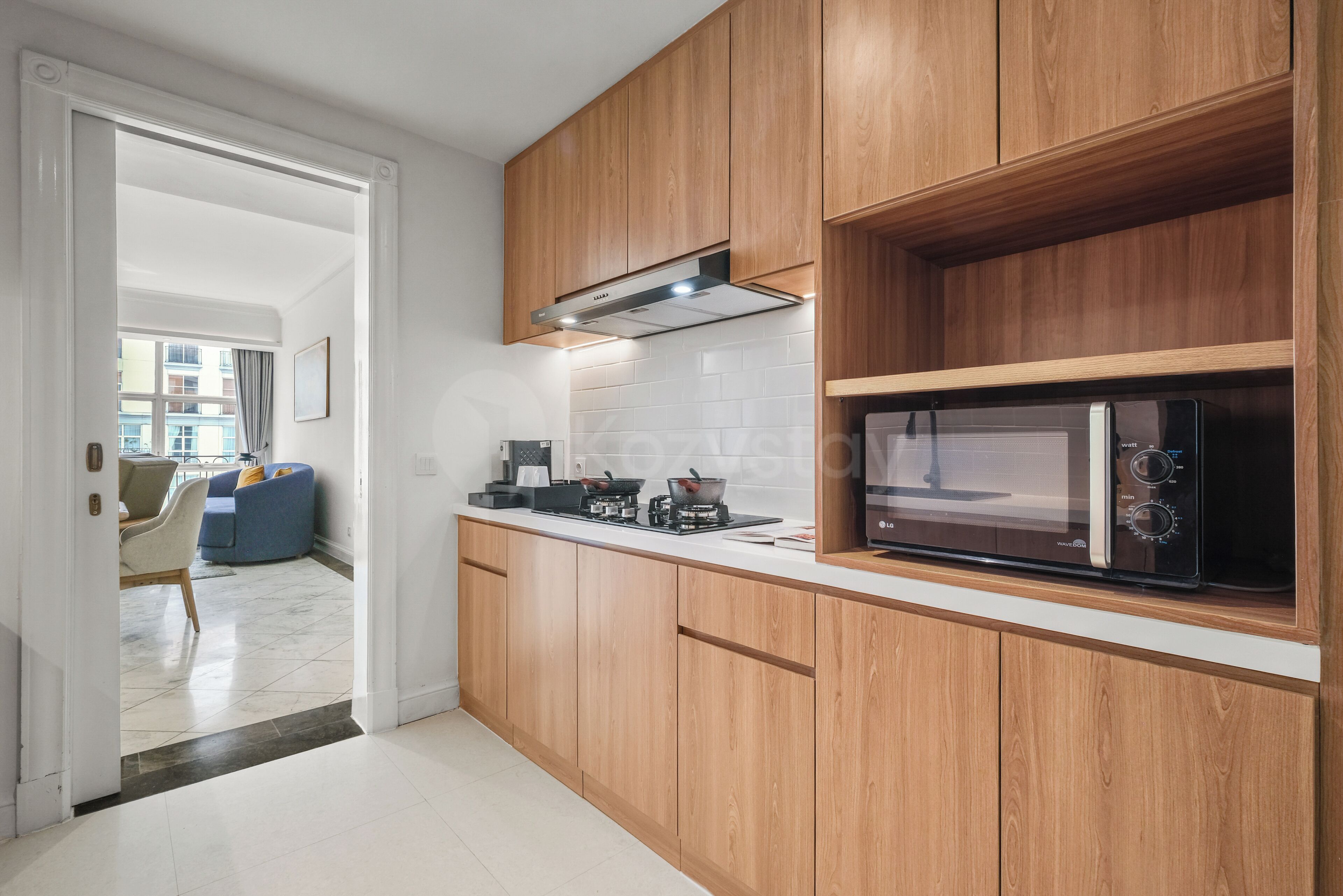 Una cocina moderna con armarios de madera, un microondas y una estufa.