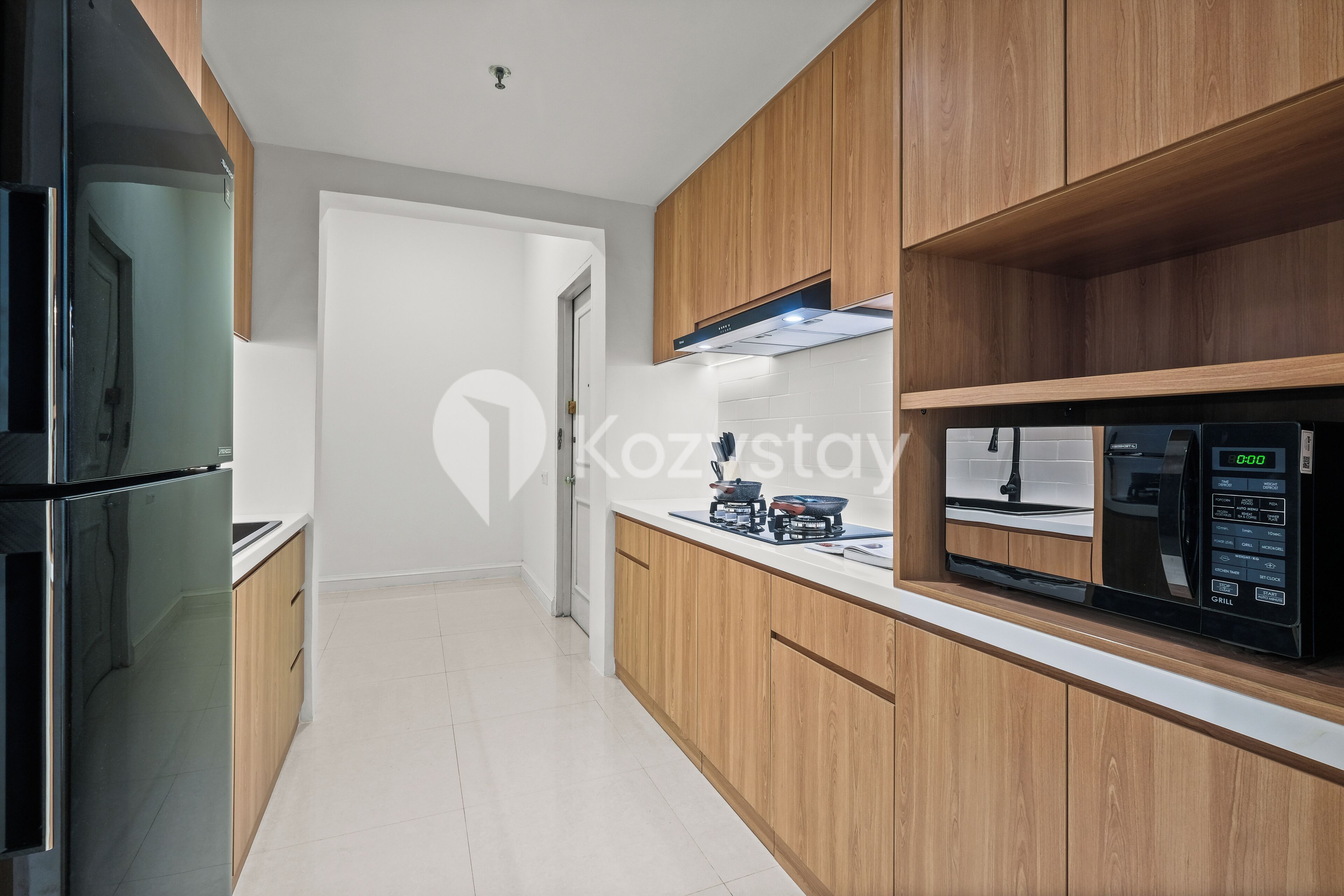 A modern kitchen with wooden cabinets, a built-in microwave, and a gas stove.