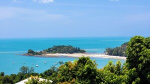 A coastal view with a beach, boats, and lush greenery. - Baan Phuttarak Villa - 4BR Private Sea View (Ko Samui)