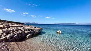 A clear blue sea with rocky shorelines and distant mountains. - La Rocca Duo - Hidden In Istria, Labin, Croatia (Labin)
