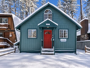 A blue cabin with a red door, numbered 42637, surrounded by snow-covered trees. - Moonridge Haus (Big Bear Lake)