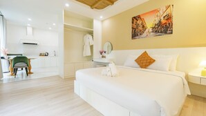 A modern hotel room with a large bed, a dining area, and a kitchen. - Hub Multi Hotel Phu Quoc (Phu Quoc)
