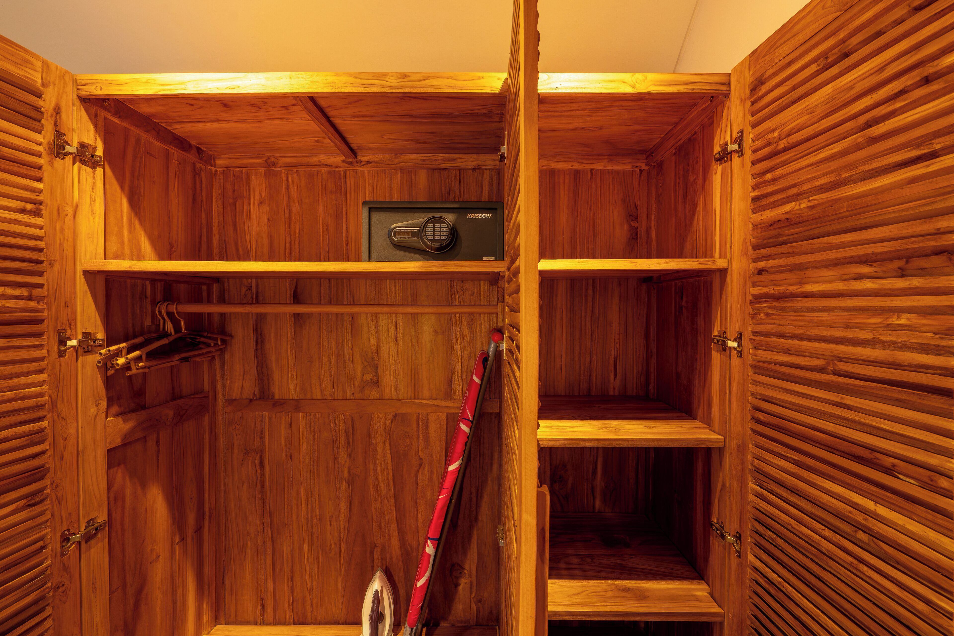 A wooden cabinet with multiple shelves and a safe.