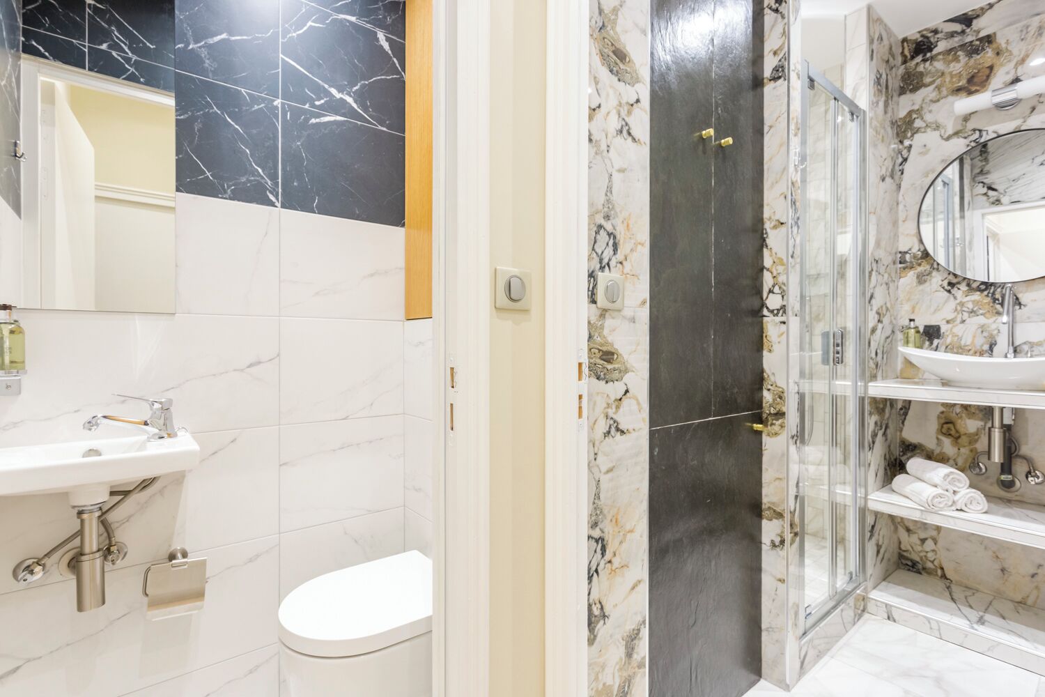 A bathroom with a white sink, toilet, and shower area.