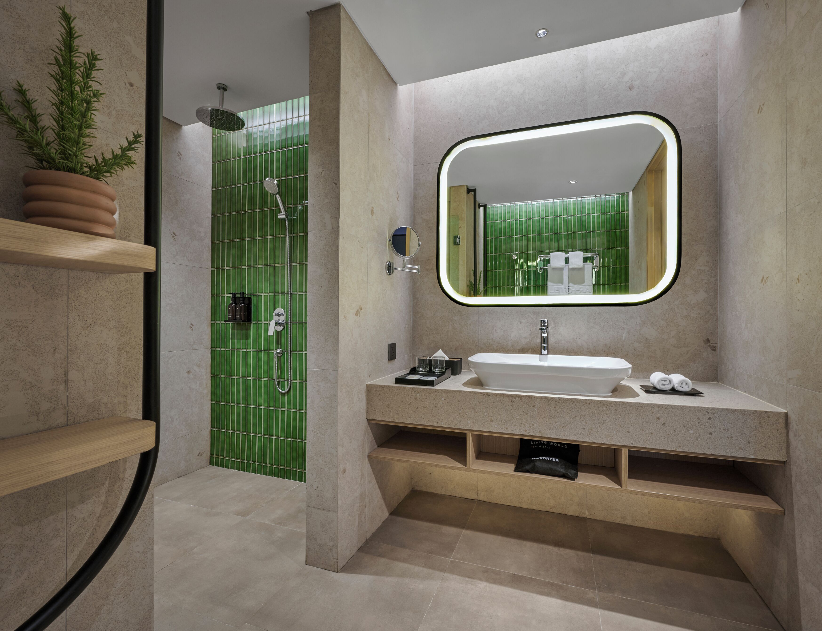 A modern bathroom with a large mirror, a sink, and a shower area.