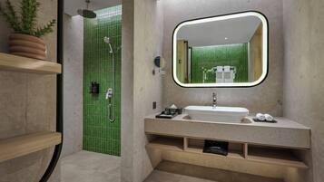 A modern bathroom with a large mirror, a sink, and a shower area.