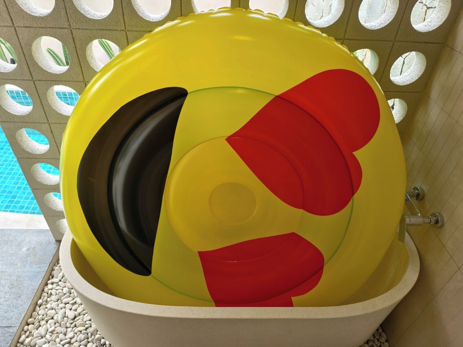 A toilet with a colorful, abstract design on the lid.