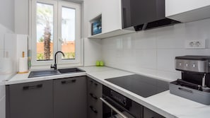 A modern kitchen with a sink, stove, and coffee machine. - Apartment Estate 2 - Island Krk by Villas Guide (Malinska)
