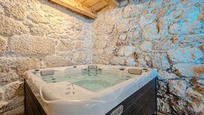 A stone-walled bathroom with a hot tub. - Villa Elefant by Villas Guide (Tribalj)