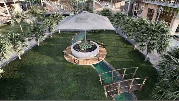 Un jardin circulaire avec un jardinier central, entouré d’une terrasse en bois et d’un espace salon couvert.