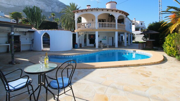 A two-story house with a swimming pool, a balcony, and a patio with chairs. - Studio in Denia with private pool (Denia)