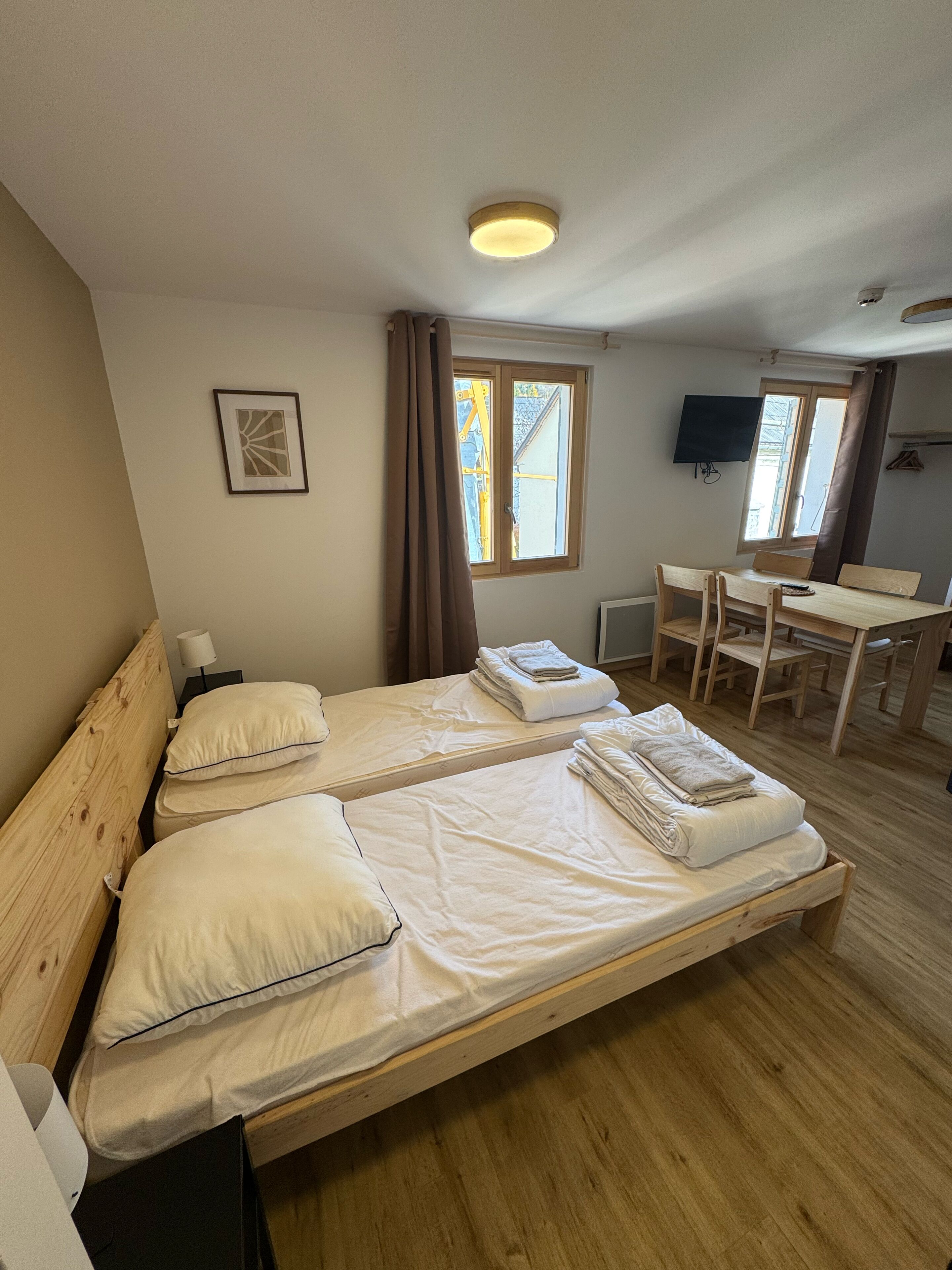 Standard Quadruple Room, City View | Living area | TV