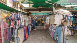 A clothing store with a variety of garments on display, including shirts, pants, and dresses.