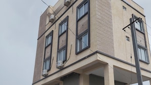 A two-story building with a sign for Hotel Bhayya Palace. - Hotel Bhavya Palace (Udaipur)