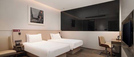 A hotel room with two beds, a desk, a chair, a TV, and a painting on the wall.