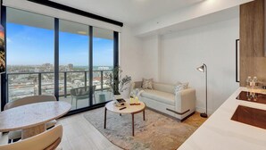 A modern living room with a balcony, a sofa, a coffee table, and a floor lamp.