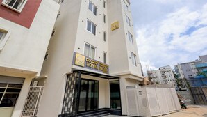 A multi-story hotel with a sign reading "ROYAL MARINE HOTEL". - Royal Mark (Bengaluru)