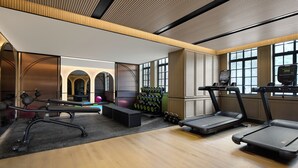 A modern gym with treadmills, dumbbells, and exercise equipment. - Haig Court (Shanghai)