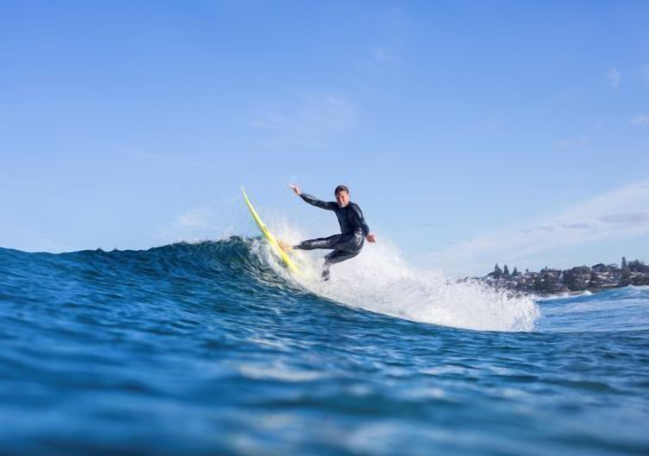 A person surfing on a wave in the ocean.