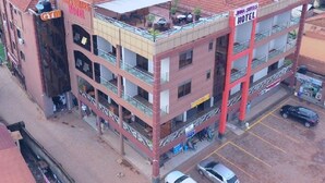 A multi-story hotel with balconies, a gym, and a rooftop terrace. - Jinna suites limited (Seeta)