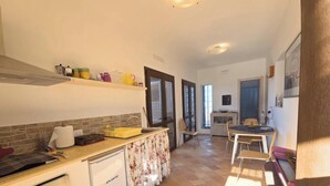 A fully equipped kitchen with a stove, oven, and dishwasher. - Dammuso - Cala Cinque Denti - AFFITTI\'CA (Pantelleria)