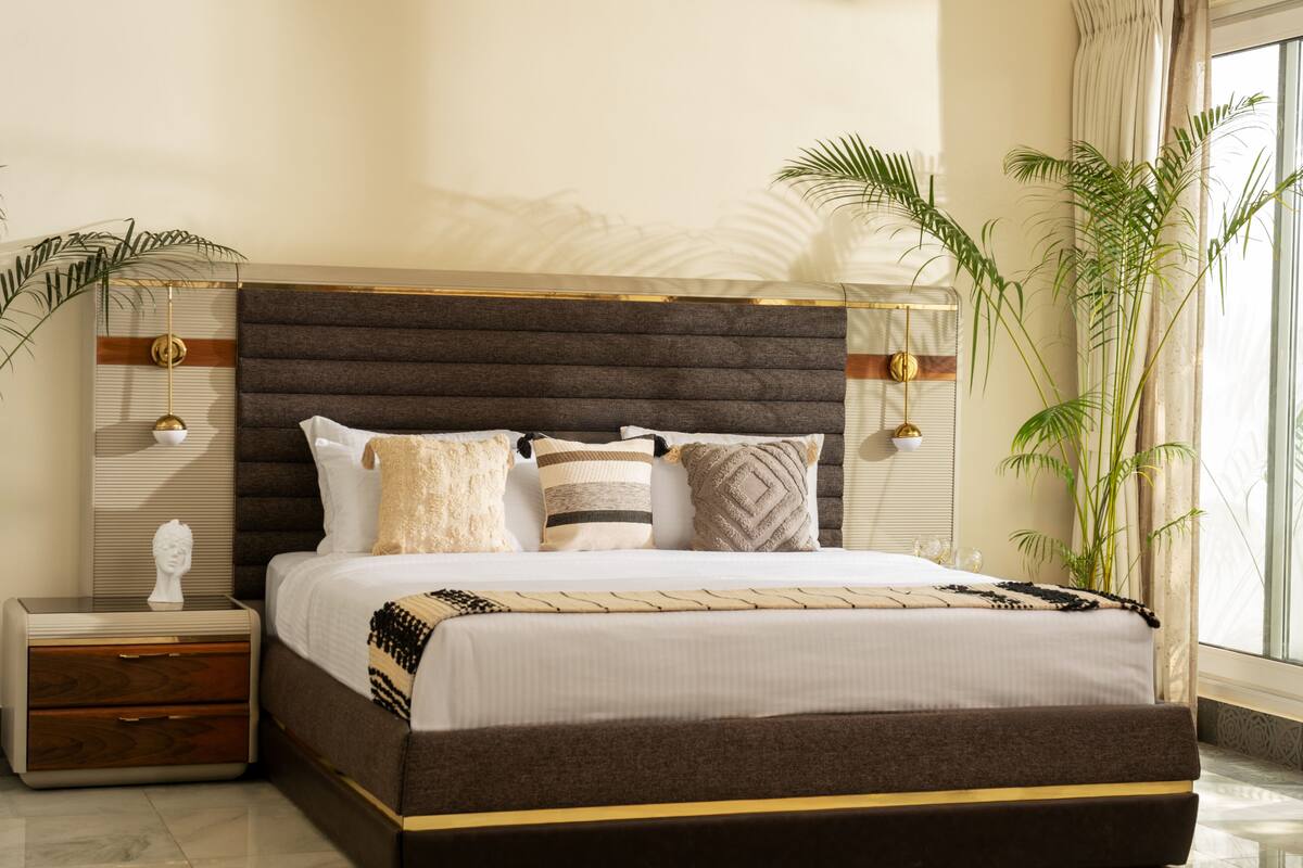 A modern bedroom with a large bed, bedside tables, and a nightstand.
