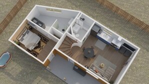 Ein zweistöckiges Haus mit Schlafzimmer, Bad, Küche, Essbereich und einer kleinen Sitzgelegenheit im Freien.