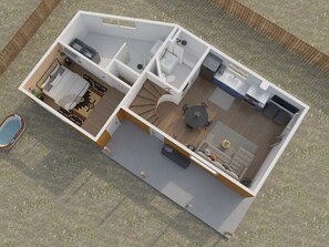 Une maison à deux étages comprenant une chambre, une salle de bain, une cuisine, un coin repas et un petit espace extérieur aménagé pour s’asseoir.