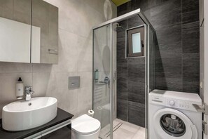 Shower, hair dryer, towels, shampoo