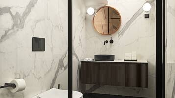 A modern bathroom with a skylight, a round mirror, a toilet, and a sink with a black basin.