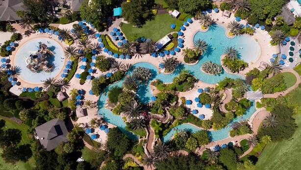 An aerial view of a resort with multiple swimming pools, palm trees, and sun loungers. - Spacious 3-bedroom apartment with AC, WiFi in amazing Kissimmee (Kissimmee)