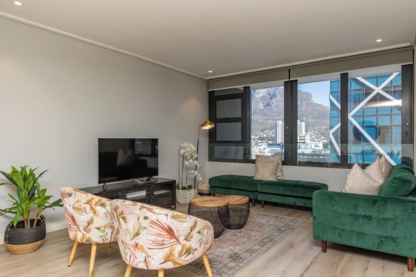 Executive Apartment, Balcony, City View | Living area | TV