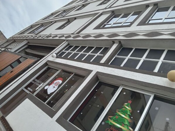 A building with multiple windows, some decorated with Christmas-themed graphics. - Twin Spot Guest House Naivasha (Naivasha)