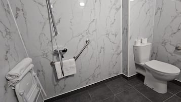 A bathroom with a marble wall, a toilet, a shower with a grab bar, and a towel rack.