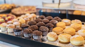 A display of various baked goods including muffins and pastries.