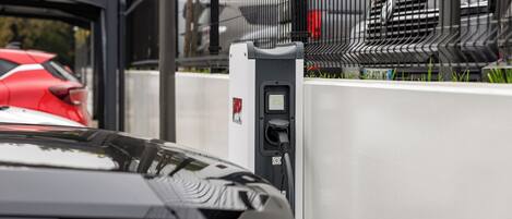 A car charging at a public electric vehicle charging station.