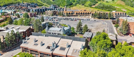 A hotel with a central courtyard, surrounded by buildings and a parking lot.