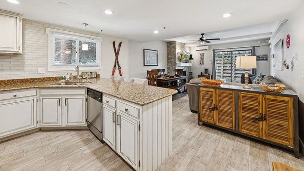 A spacious kitchen with white cabinetry, granite countertops, and a large island. - Snowblaze Condo – Walk to Park City Mtn & Main St (Park City)