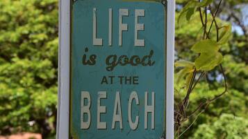 A sign with the text "LIFE is good at the BEACH".