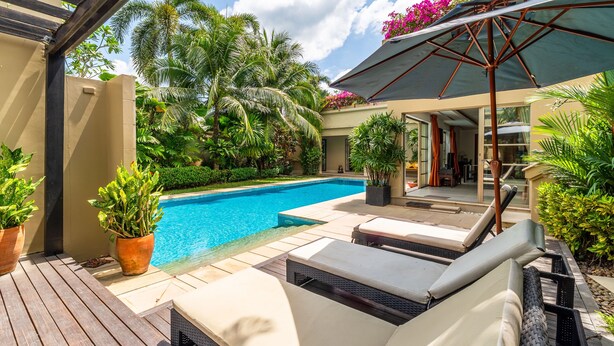 A poolside area with lounge chairs, a pergola, and potted plants. - Exotic Pool Villa Solandra in Bangtao (Choeng Thale)
