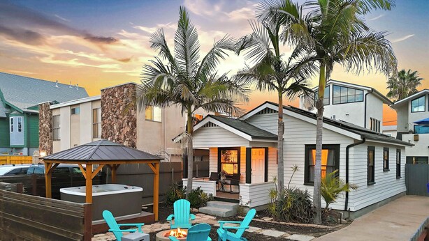 A residential area with a patio, outdoor seating, and a fire pit.
