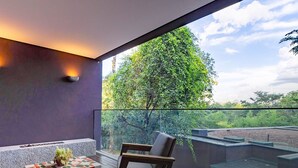 A modern balcony with a view of lush greenery and a clear sky. - Clara Arte Resort (Brumadinho)