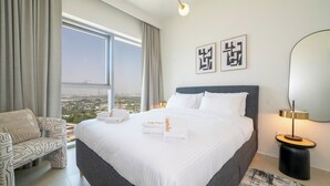 A hotel room with a large bed, a sofa, a view of the city, and a modern lamp. - Zapbed House-DT 2103 (Dubai)