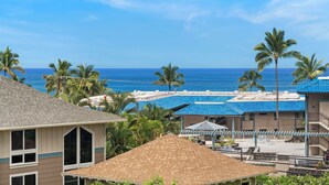 A resort with multiple buildings, a pool area, and a view of the ocean.