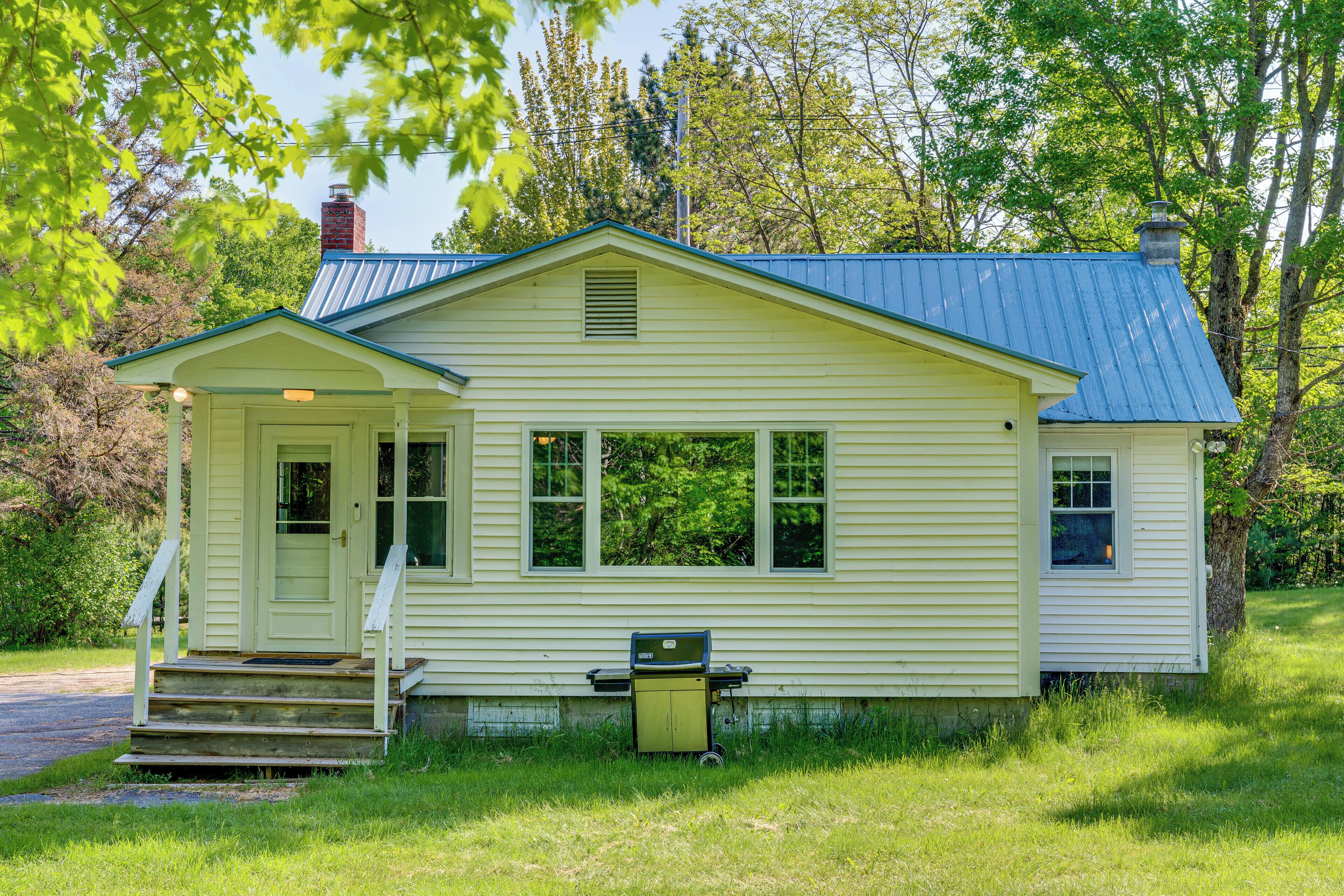 A small, single-story house with a front porch and a chimney.