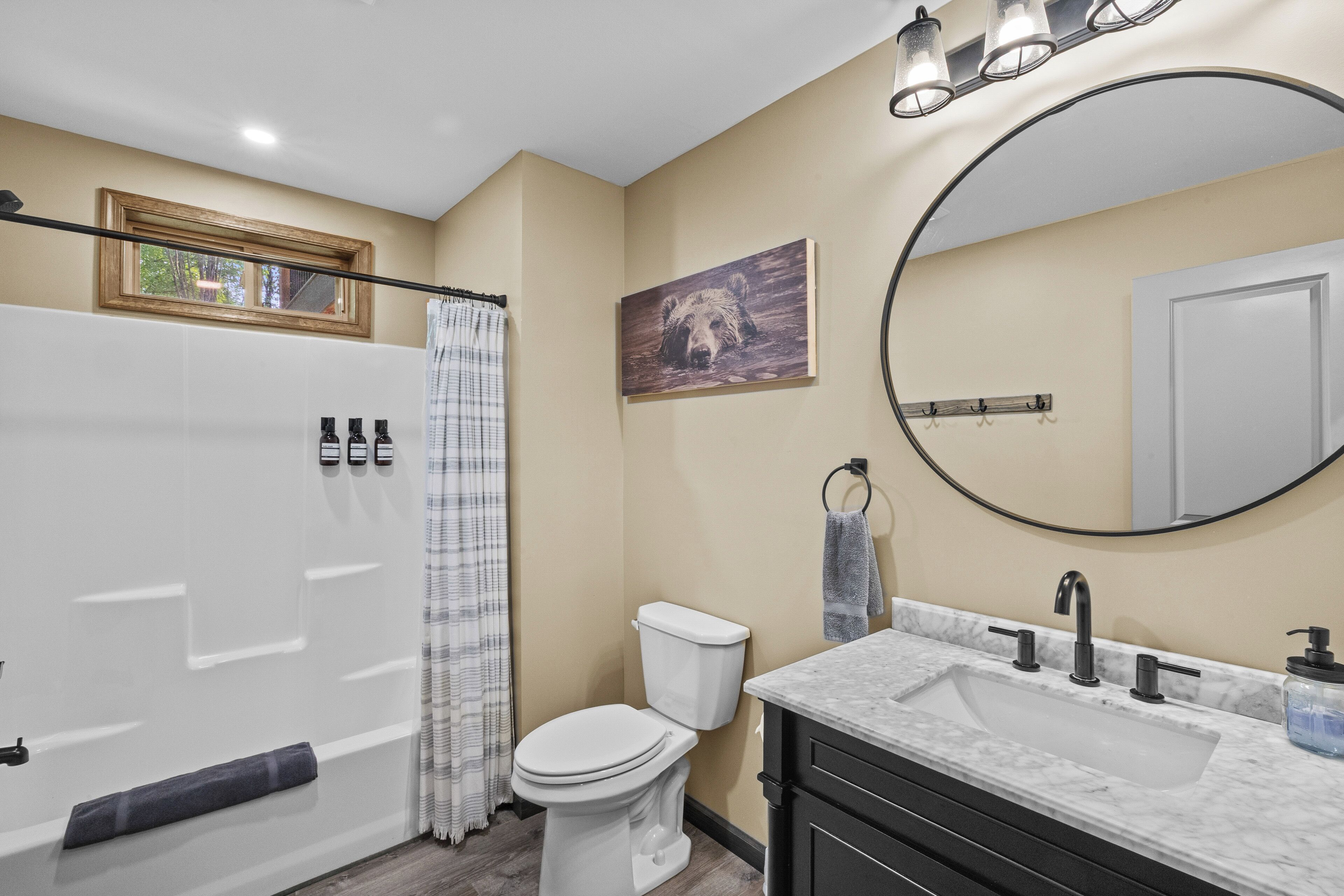 A bathroom with a toilet, sink, and shower.